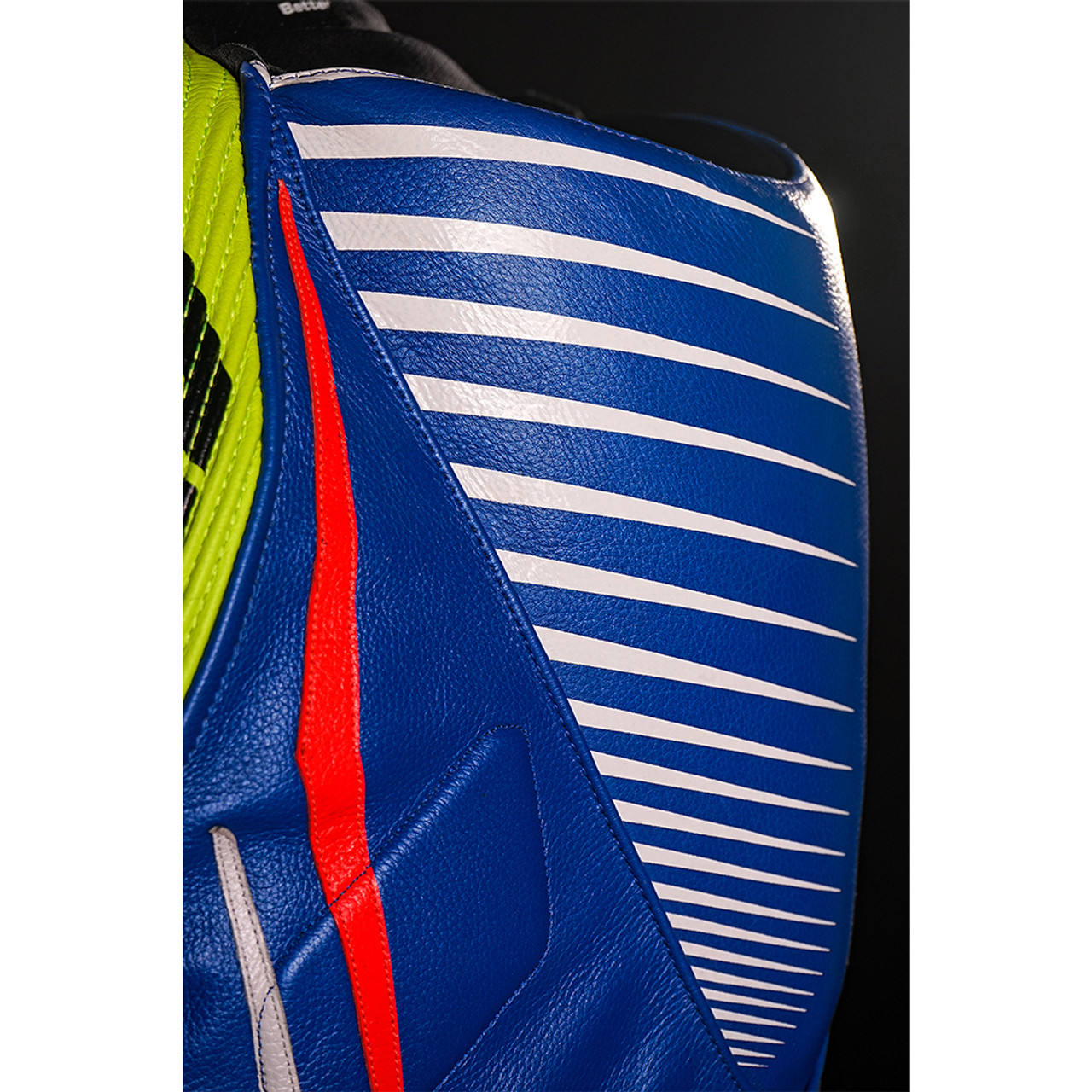 Three-quarter view of blue cowhide one-piece motorcycle suit with padded chest, articulated sleeves and replaceable knee sliders