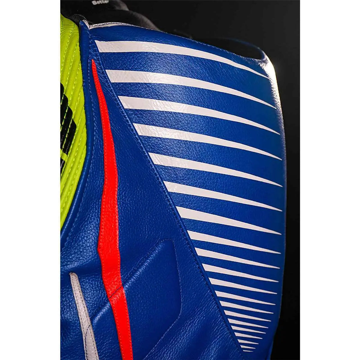 Front view of blue one-piece cowhide motorcycle racing suit with white, red and neon yellow panels and external knee sliders