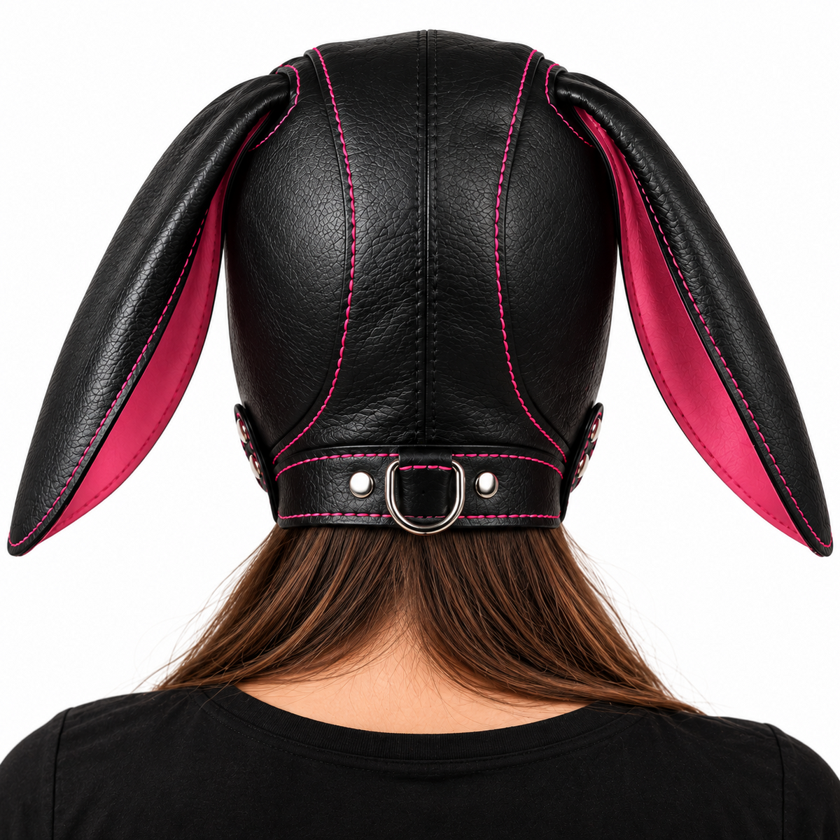 Rear view of black leather floppy-ear pup hood with pink contrast stitching, bright pink ear interiors and a silver-tone lower D-ring.