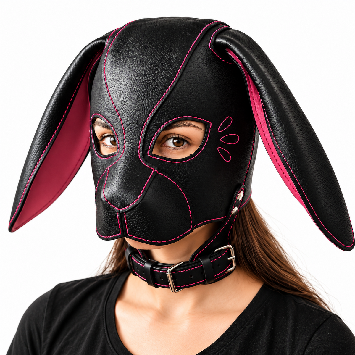 Front angled view of black leather pup hood with long floppy ears, pink inner panels, pink stitching, open eye cutouts and buckled collar.