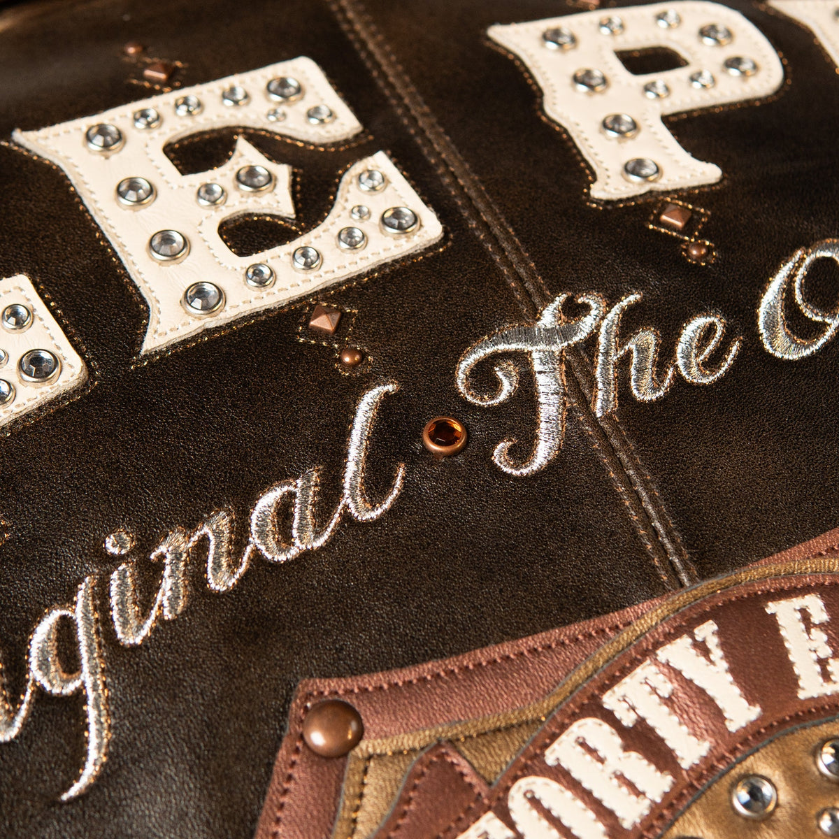 Front of distressed brown Pelle Pelle-style 48th Anniversary leather jacket with studded P shield, 1978 numerals and B sleeve badge