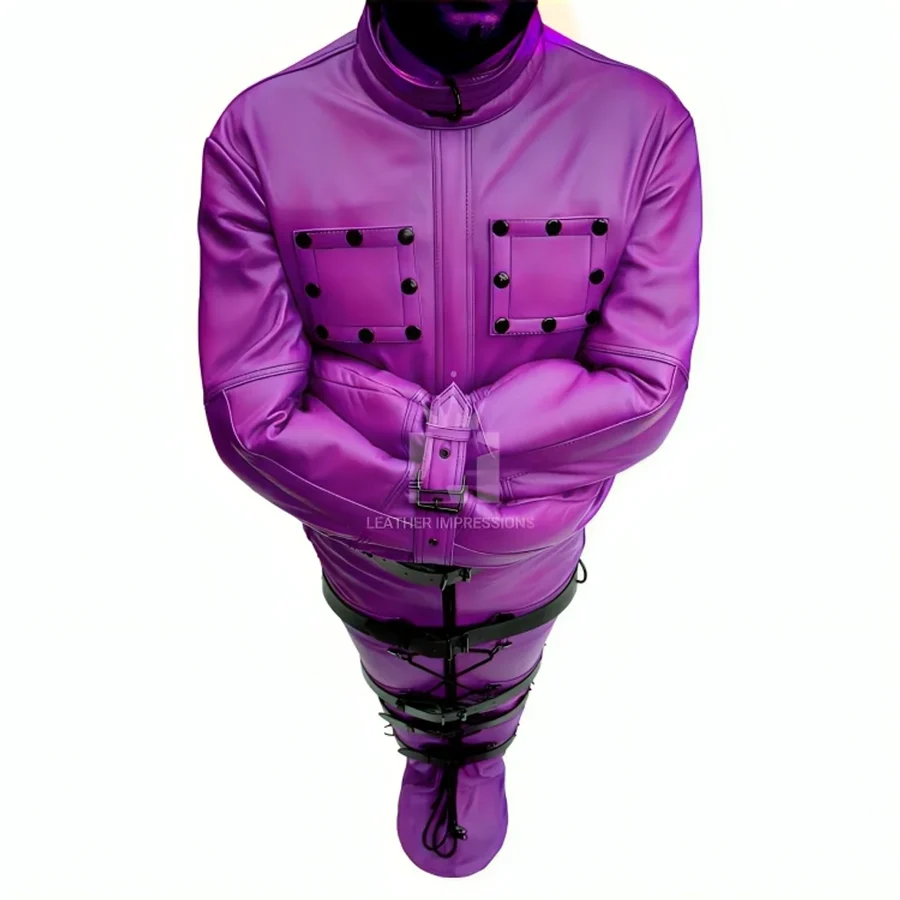 Upper angled view of purple leather restraint suit showing crossed sleeves, wrist buckle, studded chest panels and black lower straps.