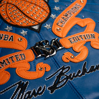 Women's blue and orange leather varsity jacket, lower back artwork detail, showing New York basketball graphics and contrasting decorative details.