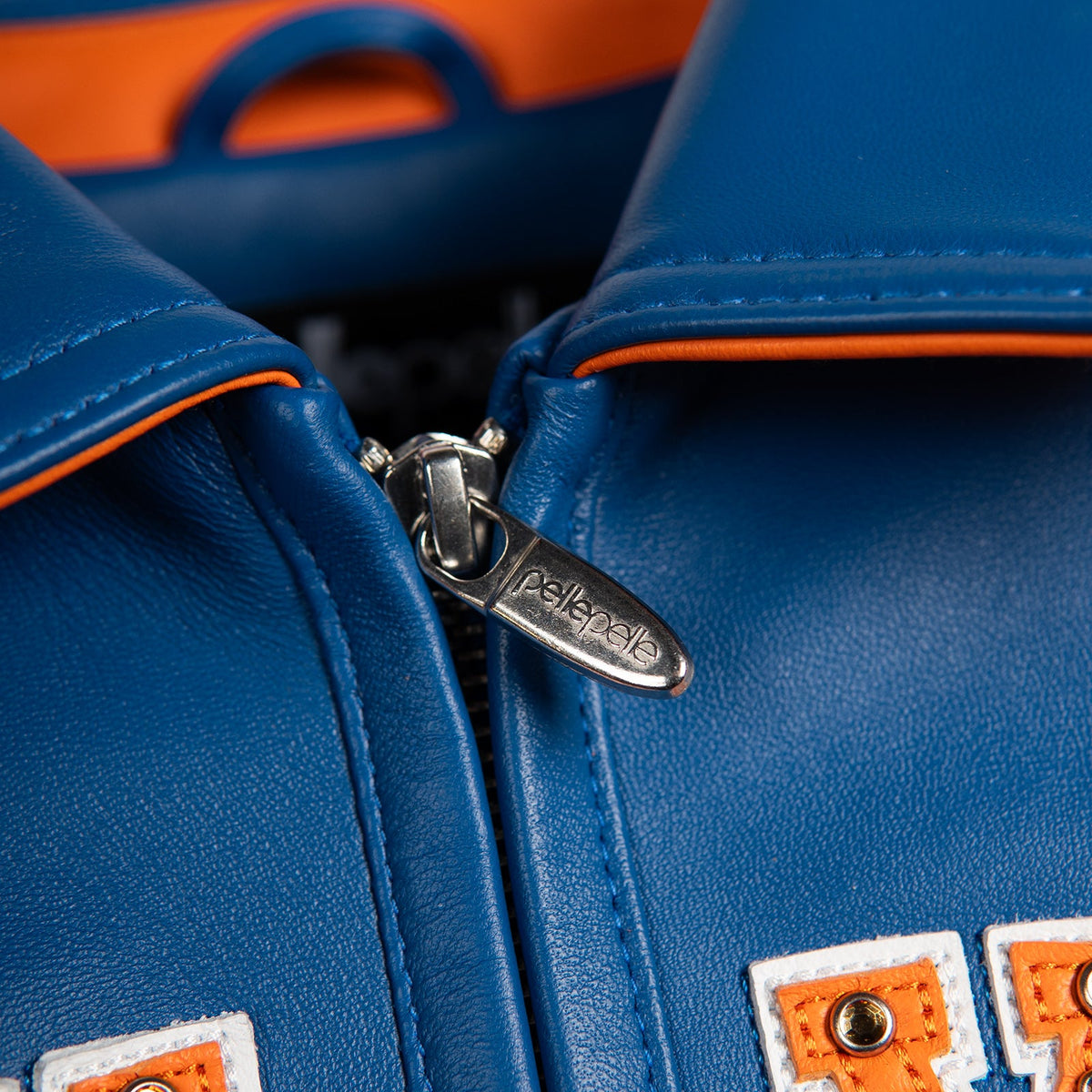Women's blue and orange leather varsity jacket, collar and zipper detail, showing New York basketball graphics and contrasting decorative details.
