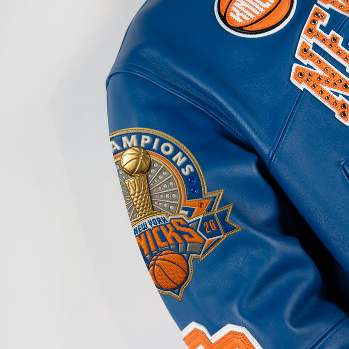 Women's blue and orange leather varsity jacket, sleeve trophy patch, showing New York basketball graphics and contrasting decorative details.
