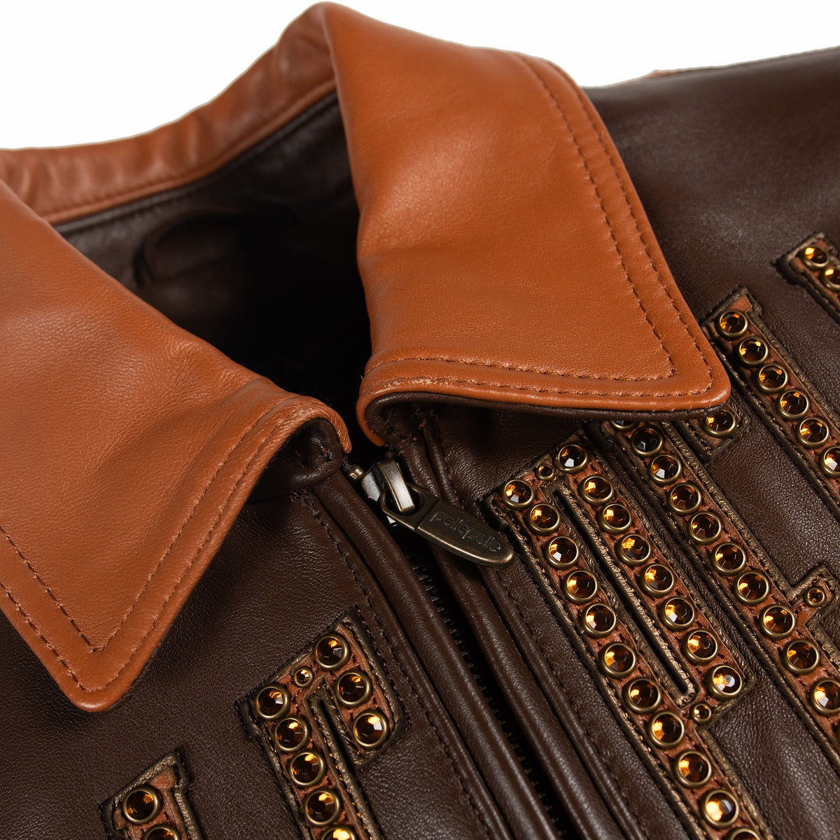 Women's brown colorblock leather racing jacket, collar and zipper detail, with caramel and olive panels and decorative metallic accents.
