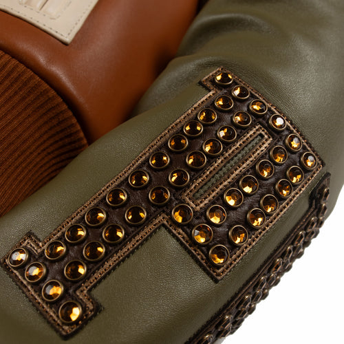Women's brown colorblock leather racing jacket, olive sleeve applique detail, with caramel and olive panels and decorative metallic accents.