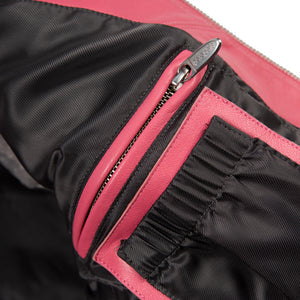 Women's pink and black leather varsity jacket, interior zip pocket, featuring contrast panels and decorative lettering in the product photo.