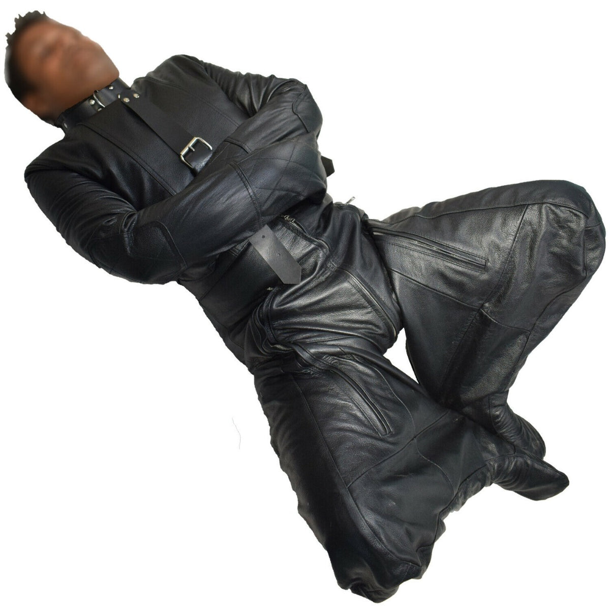 Close front view of black genuine leather suit with crossed enclosed sleeves, shaped knee panels, chest buckle and covered feet.