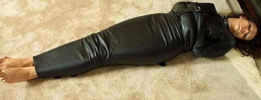 Full-length view of black genuine leather straitjacket sleep sack with crossed sleeves, a high neckline and an open foot-end design.