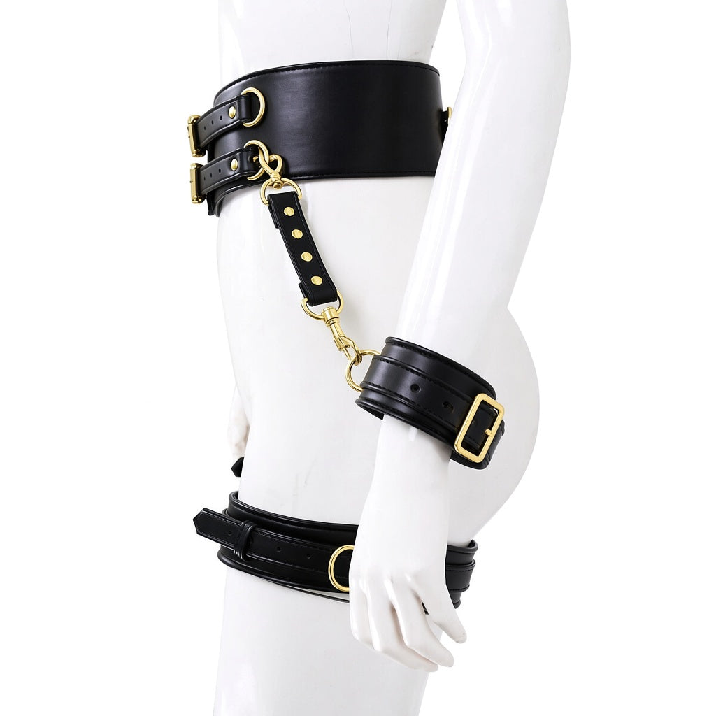 Side view of black genuine leather waist, wrist and thigh harness set with adjustable buckle straps and gold-tone rings on a white mannequin.