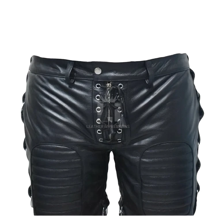 Close front view of black leather shorts showing metal eyelets, crossed lacing over a zipper, belt loops and stitched ribbed thigh panels.