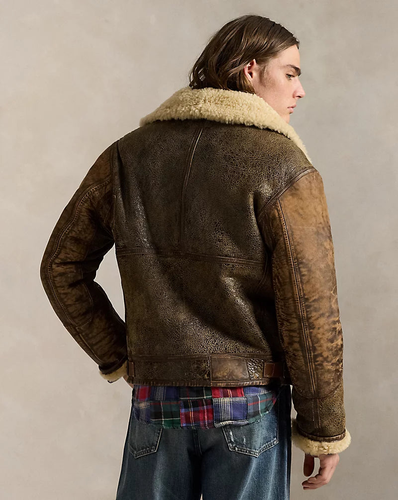 Rear view of men's brown leather aviator jacket with cream collar, contrast sleeve panels, stitched back seams and side waist tabs.