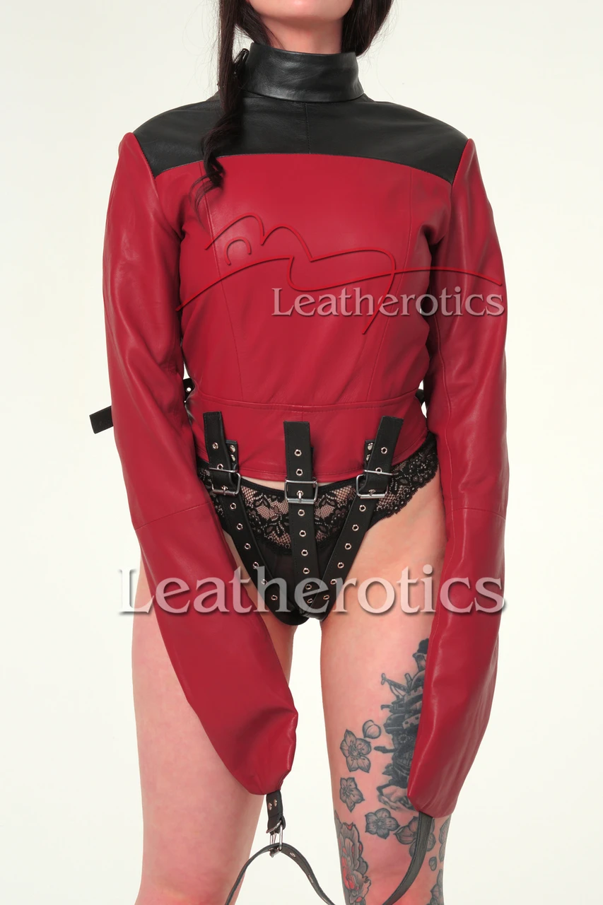 Red and black leather straitjacket, front view with extended enclosed sleeves, contrasting shoulder panel and three lower buckle straps.