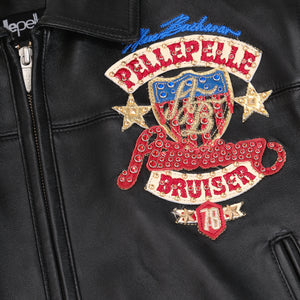 Women's black leather eagle patch bomber jacket, close-up of red, blue and gold embellished chest crest and decorative lettering.