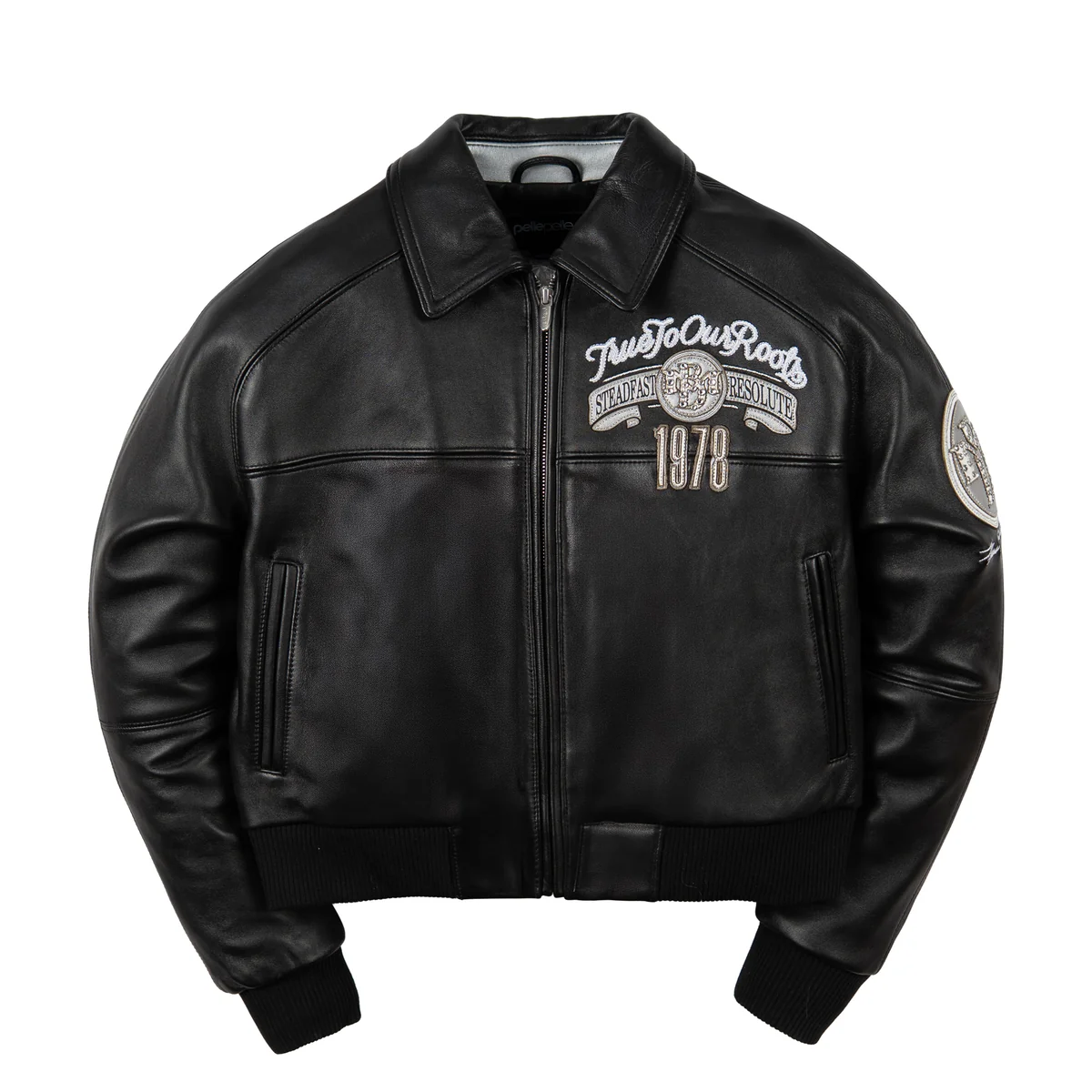 Front of women's black genuine leather bomber jacket with silver-tone chest crest, 1978 applique, pointed collar and ribbed trim.