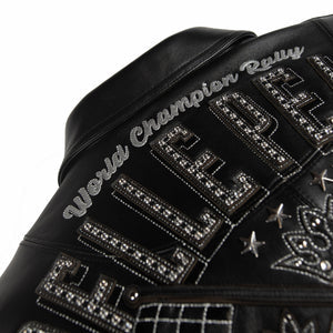 Upper back detail of black leather jacket with World Champion Rally script, large embellished lettering and crossed racing flag motifs.
