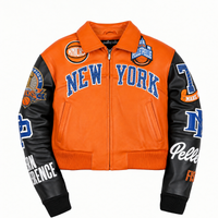 Front of women's orange and black genuine leather varsity jacket with New York lettering, sleeve patches, zip front and ribbed trim.