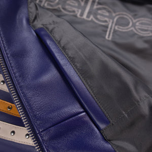 Inside view of purple leather varsity jacket with dark patterned lining, purple leather facing and an interior welt pocket opening.