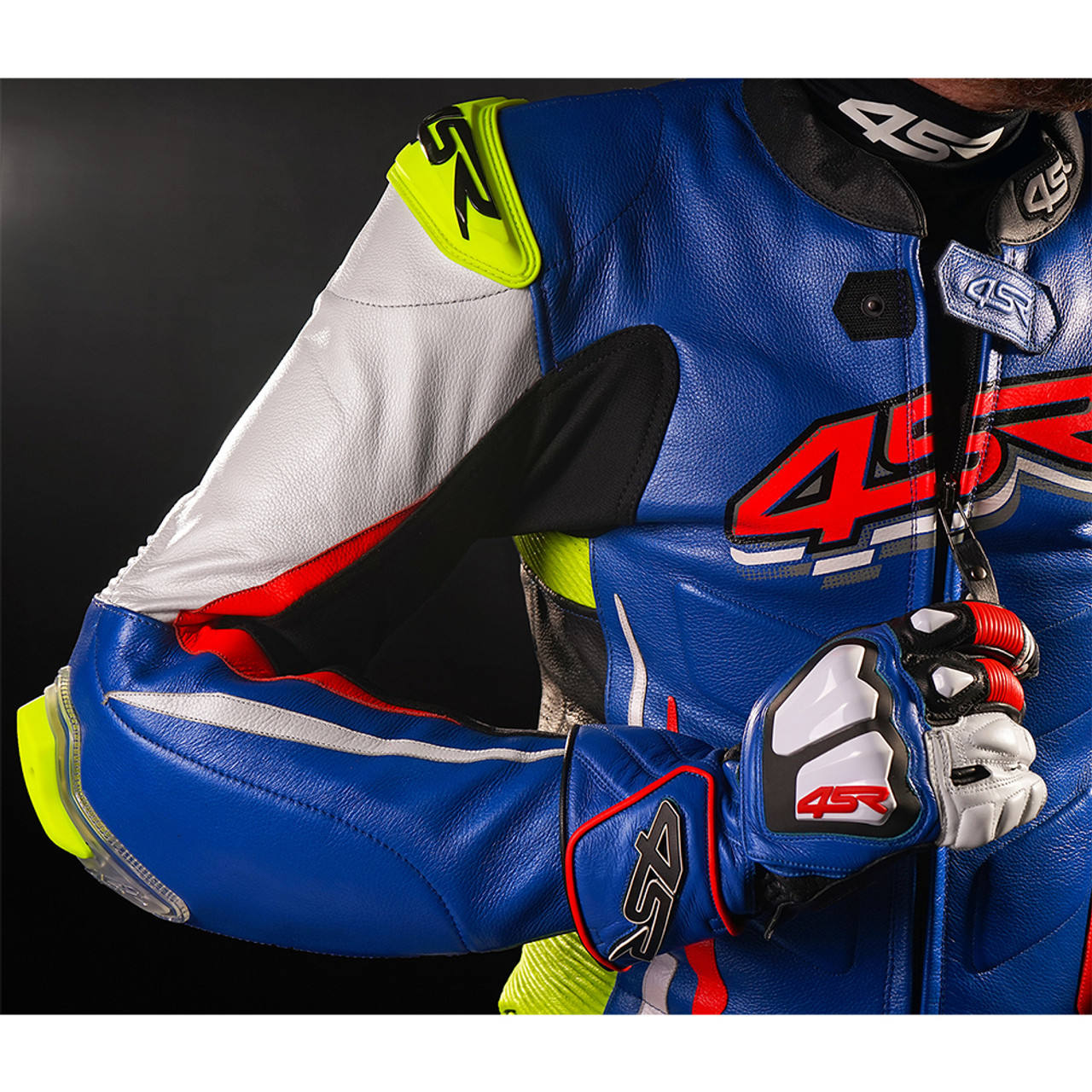 Front view of blue one-piece cowhide motorcycle racing suit with white, red and neon yellow panels and external knee sliders leathertaboo.com