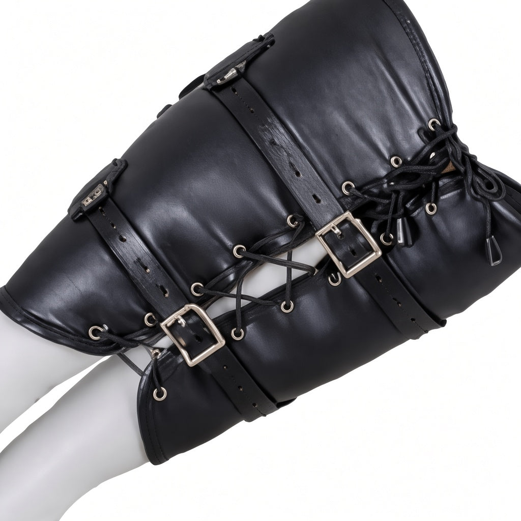 Close-up of black leather binder panels showing eyelet lacing, two adjustable buckle straps, silver-tone hardware and stitched edges.