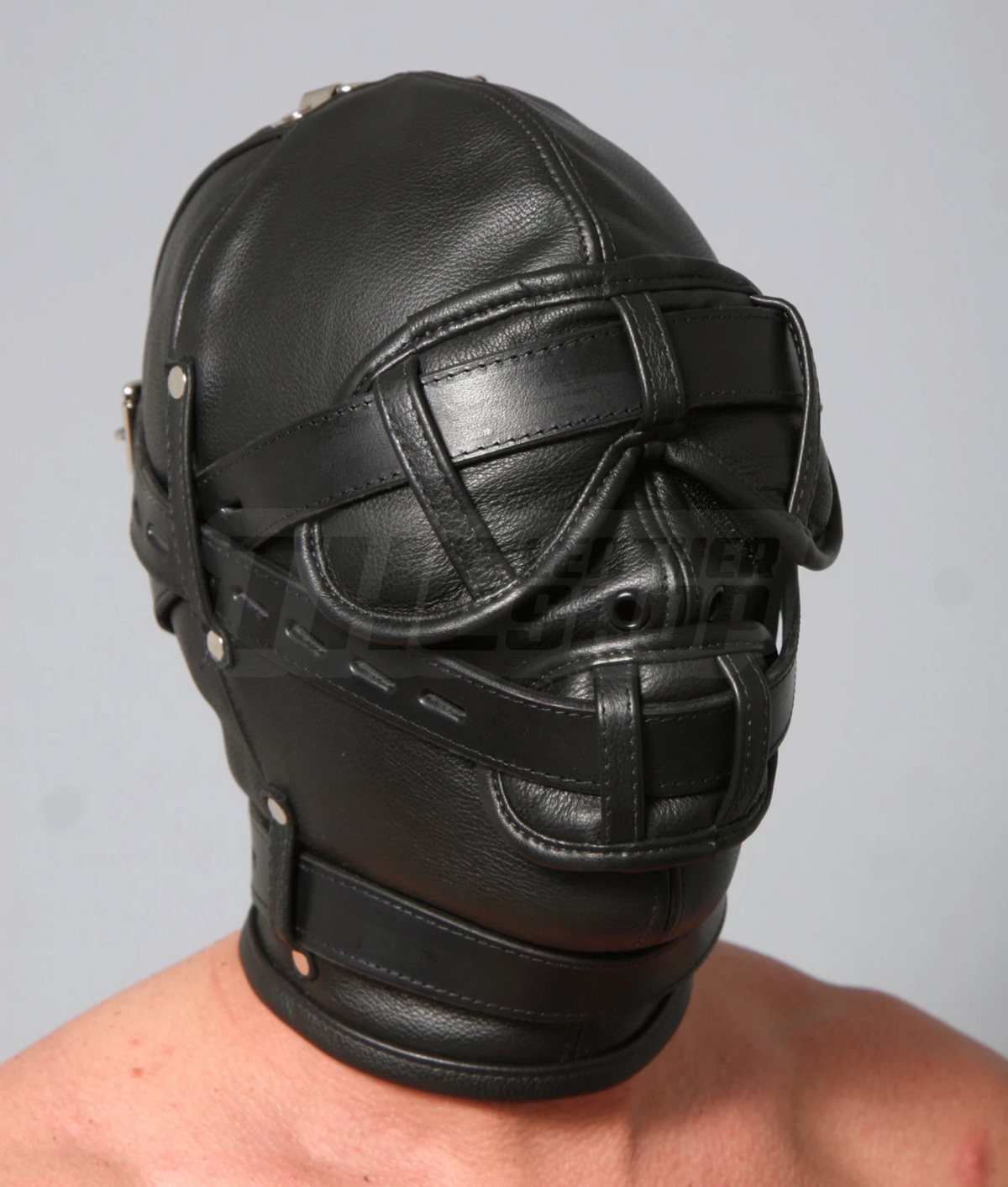 Front angled view of black leather hood with contoured eye and mouth covers, horizontal straps, nose eyelets and a wide neck band.