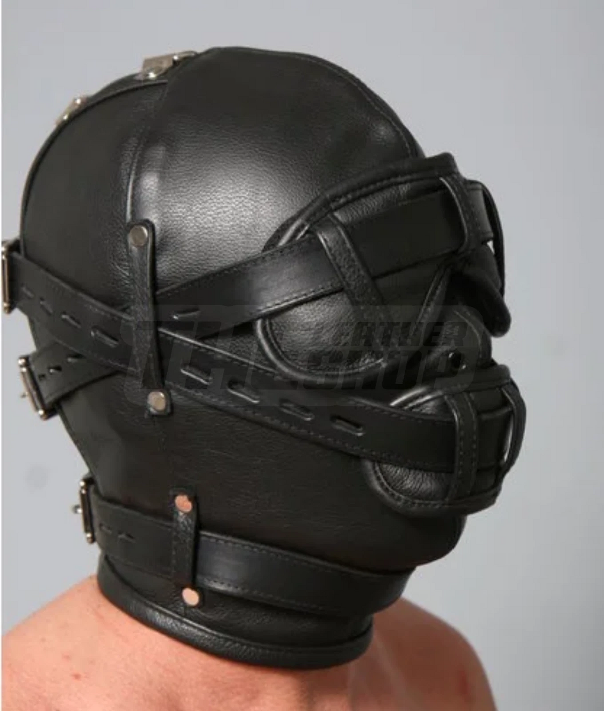 Side view of black leather full-head hood showing layered face covers, adjustable buckle straps, riveted keepers and stitched crown panels.