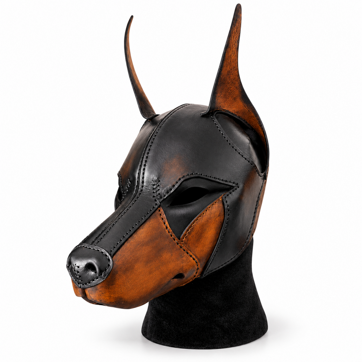 Angled view of a black and brown leather canine mask showing the long muzzle, brown cheek panels, tall ears and open eye cutout detail.