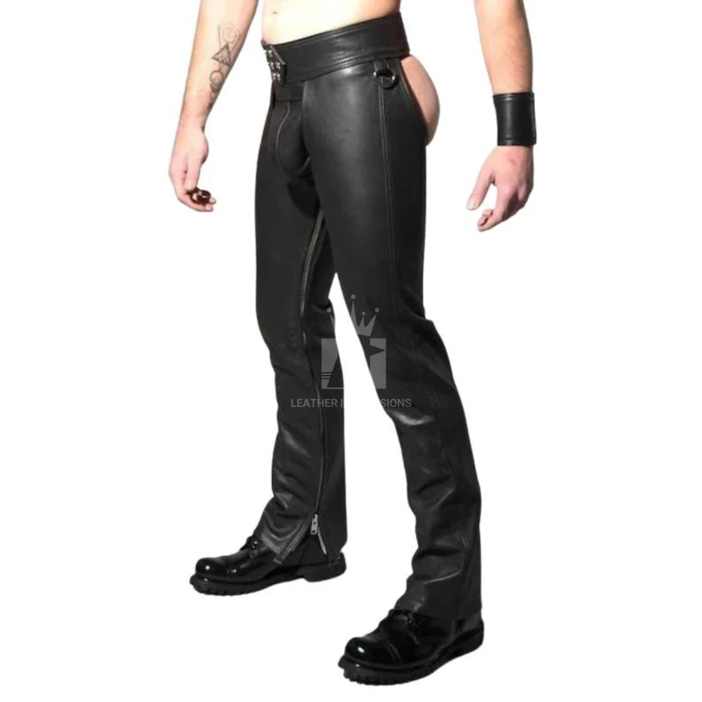 Angled view of men's black leather assless chaps showing the open seat, hip ring, long leg panels and zip openings at the ankles.