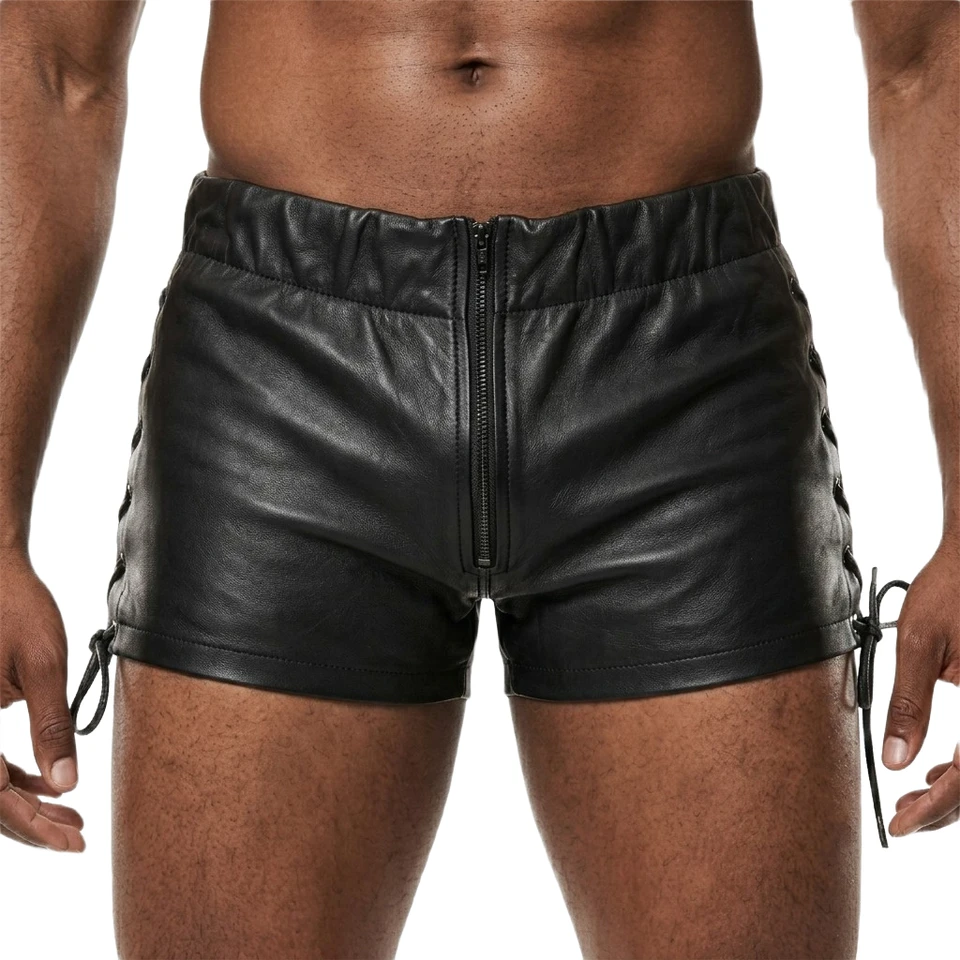 Close front view of men's black leather shorts showing the central zipper, gathered waistband, short stitched hems and side lace-up cords.