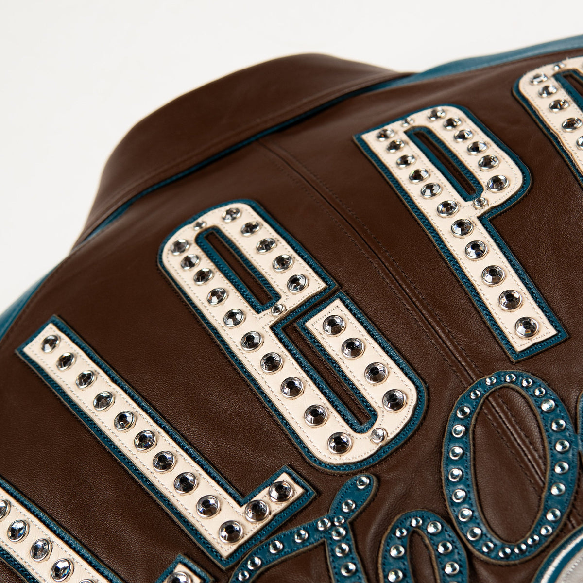 Handmade two-tone leather bomber jacket, brown body, teal raglan sleeves, ribbed cuffs and full zip, back view