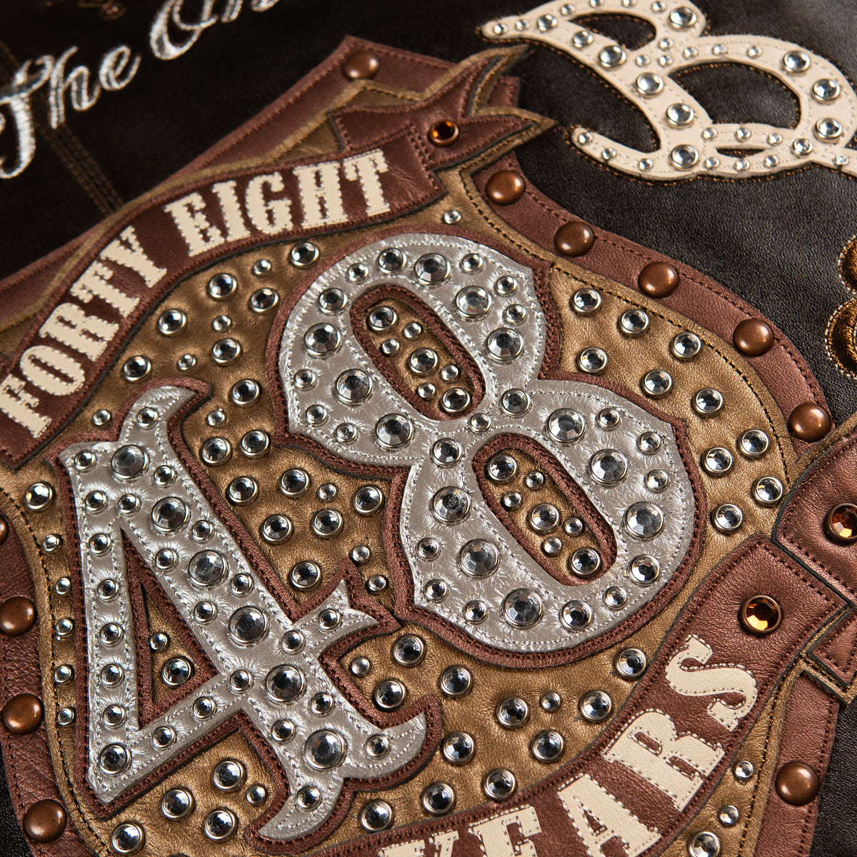 Studded 48th Anniversary back panel on distressed brown leather with Limited Edition script and silver scroll flourishes