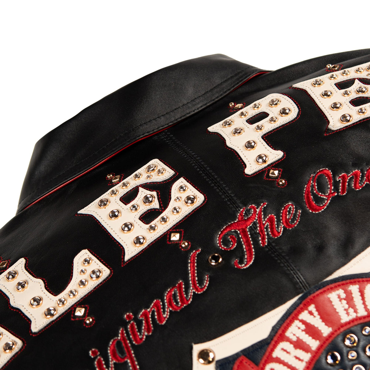 Large 48 crest surrounded by decorative lettering, gold-tone scrollwork and red accents across the black jacket's back