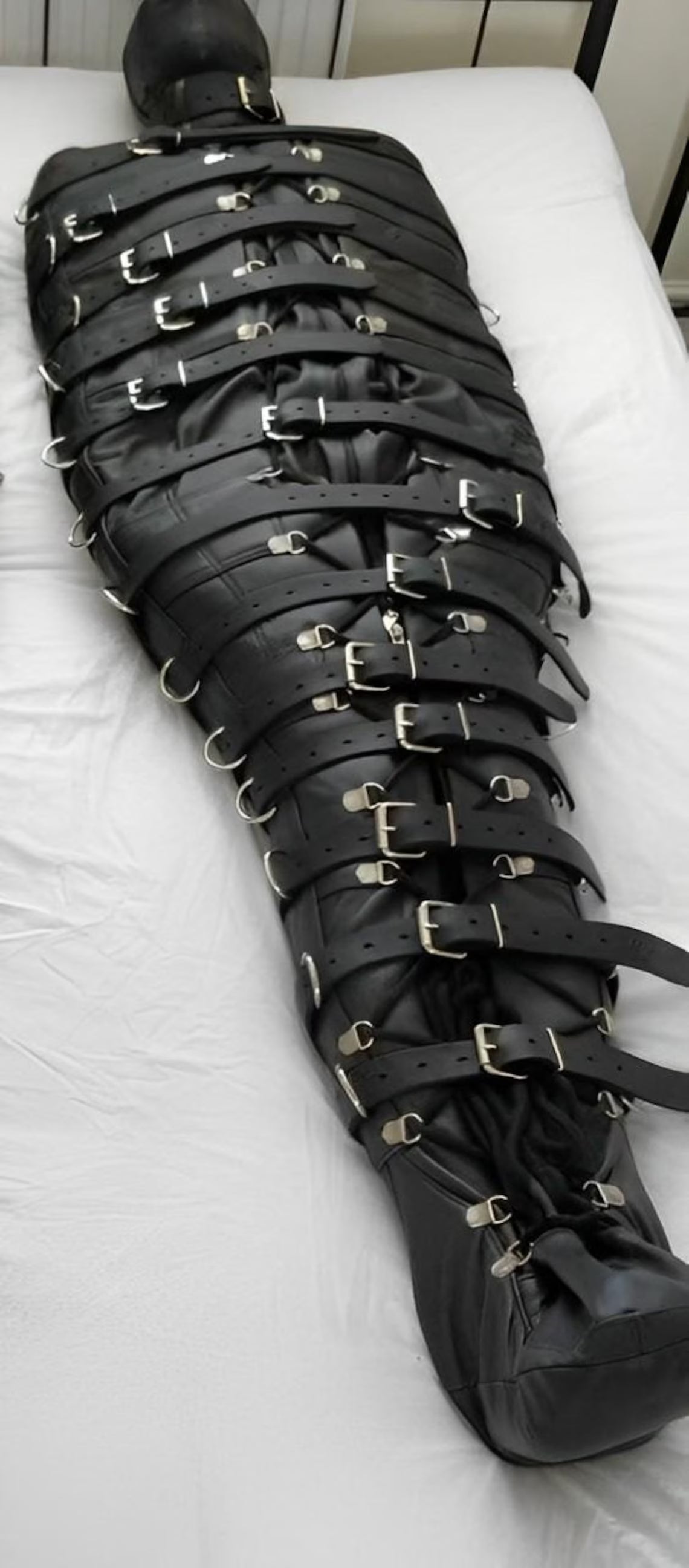 Genuine leather bondage sleepsack laid flat, showing full-length zippers and reinforced straps for secure BDSM restraint by leathertaboo.com