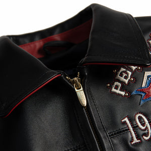 Women's black leather anniversary bomber jacket, collar and zip detail, with red and blue crest artwork and decorative gold-toned accents.