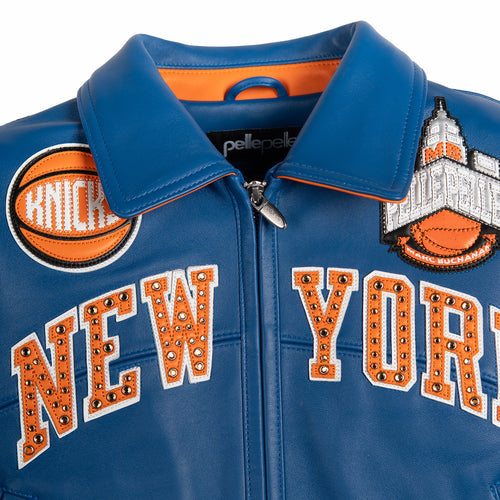 Women's blue and orange leather varsity jacket, upper front view, showing New York basketball graphics and contrasting decorative details.