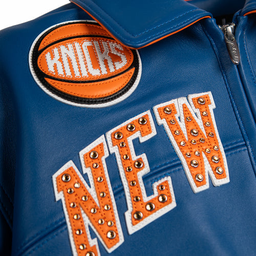 Women's blue and orange leather varsity jacket, basketball chest patch, showing New York basketball graphics and contrasting decorative details.