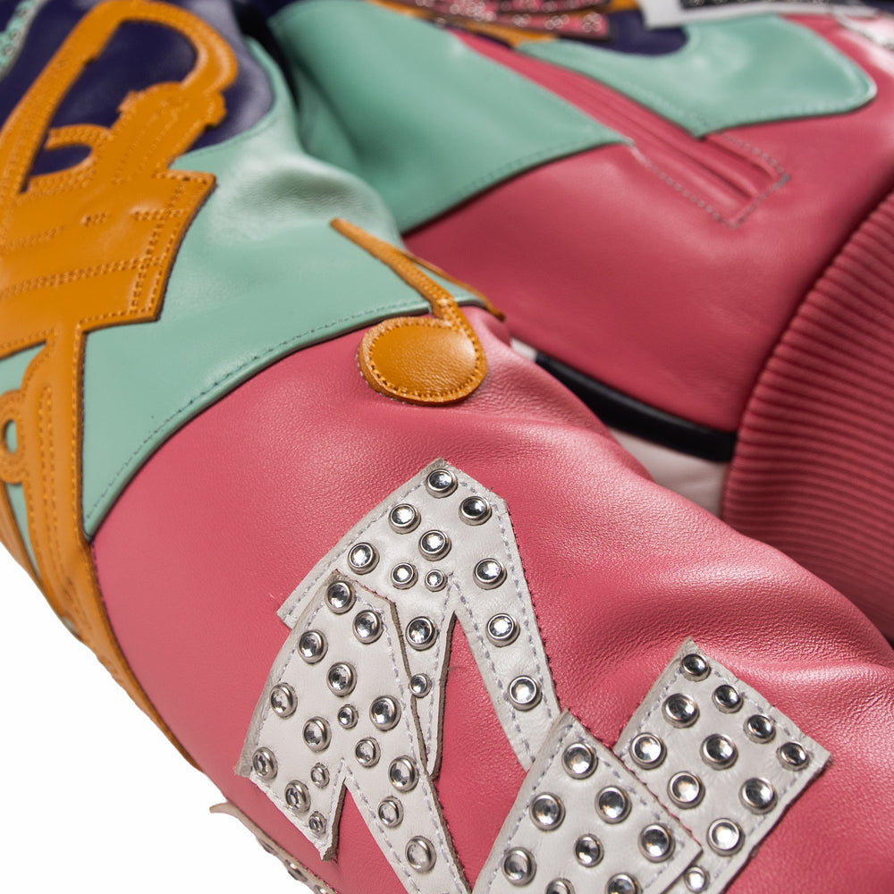 Sleeve detail of women's multicolor leather music jacket with pink leather, mint panels, yellow notes and embellished white letter appliques.