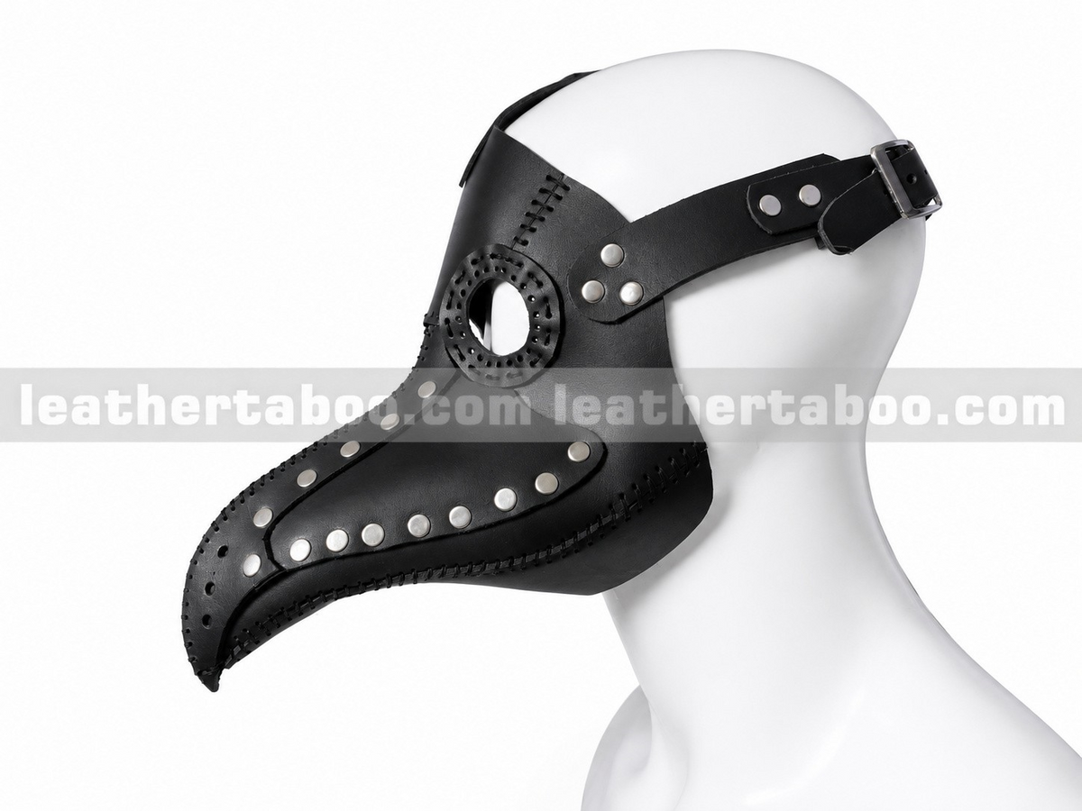 Side view of black leather plague doctor mask showing long beak, circular eye opening, riveted panels and adjustable buckle strap on a mannequin.