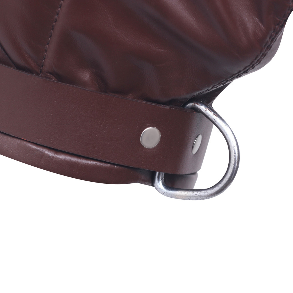 Close detail of a brown leather hood's neck strap showing silver-tone rivets, a large metal ring and stitched leather edges on white.
