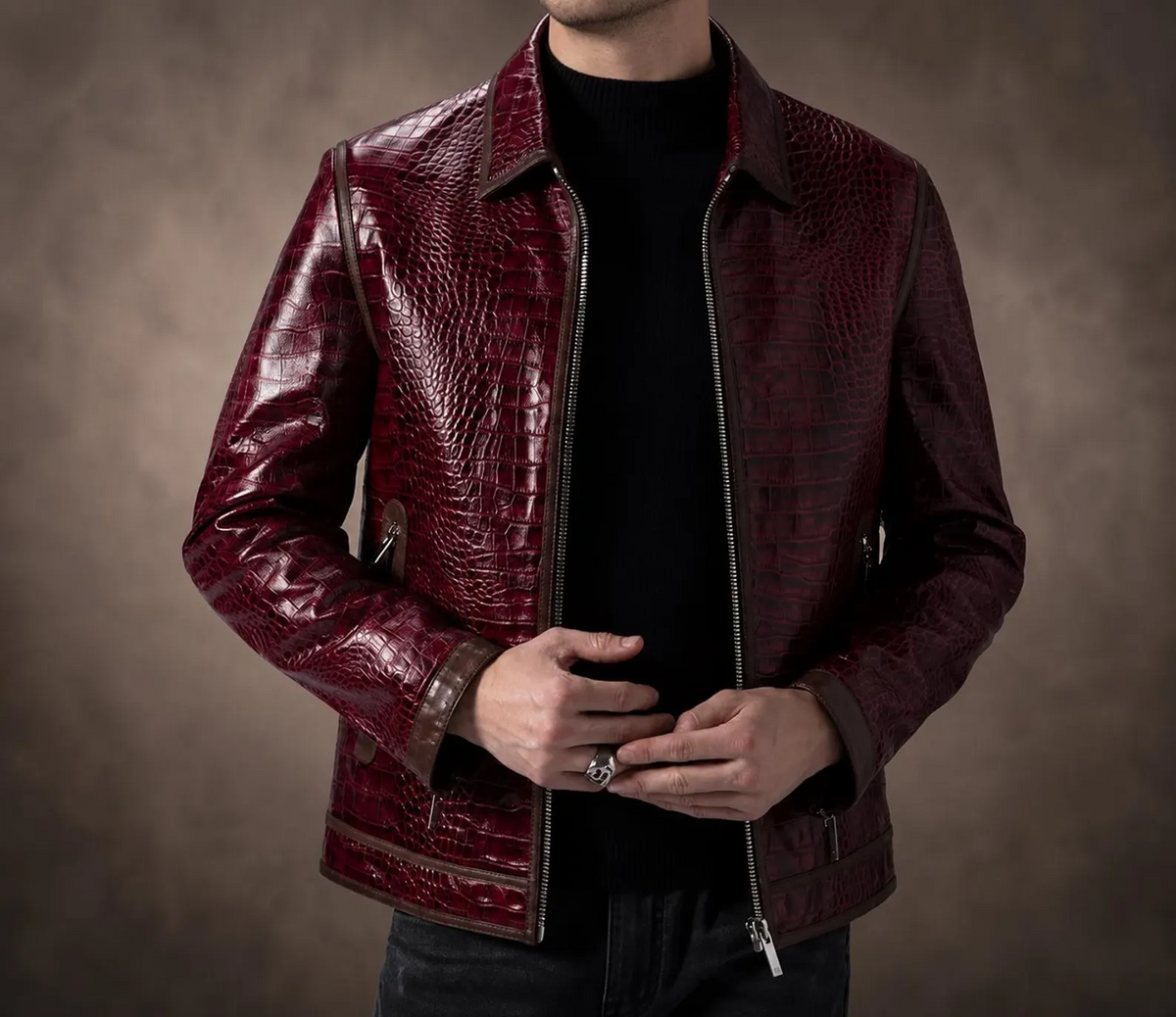 Front view of men's burgundy red crocodile textured genuine leather jacket with a zip closure, pointed collar and contrast trim.