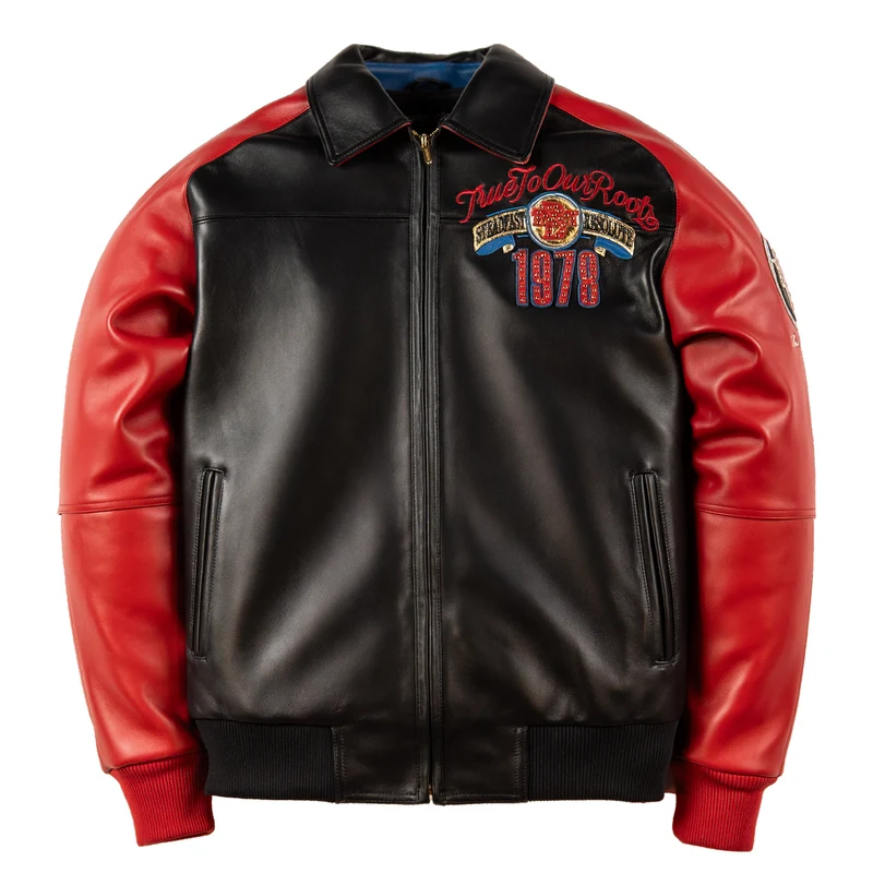 Front of red and black True To Our Roots leather jacket with zip closure, pointed collar, chest graphics and ribbed trim.