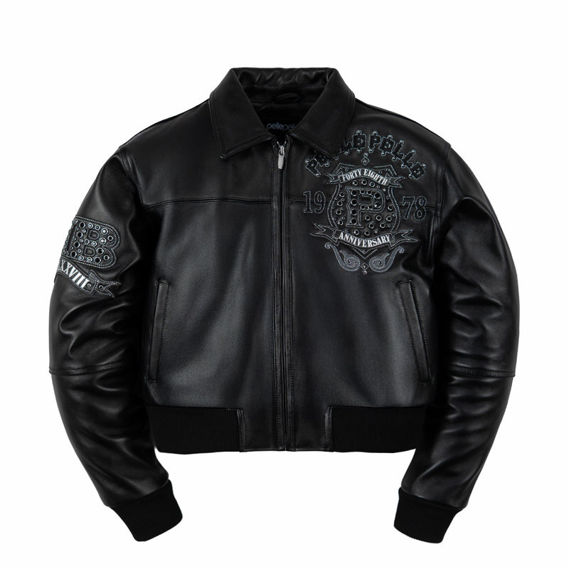 Front of women's black genuine leather bomber jacket with embellished chest crest, pointed collar, zip front and black ribbed trim.