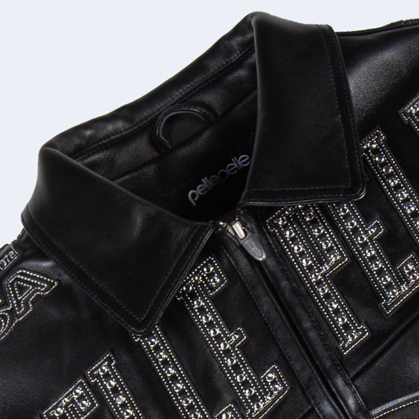 Collar and zip detail of women's black genuine leather racing jacket with pointed collar, embellished chest lettering and dark zipper.